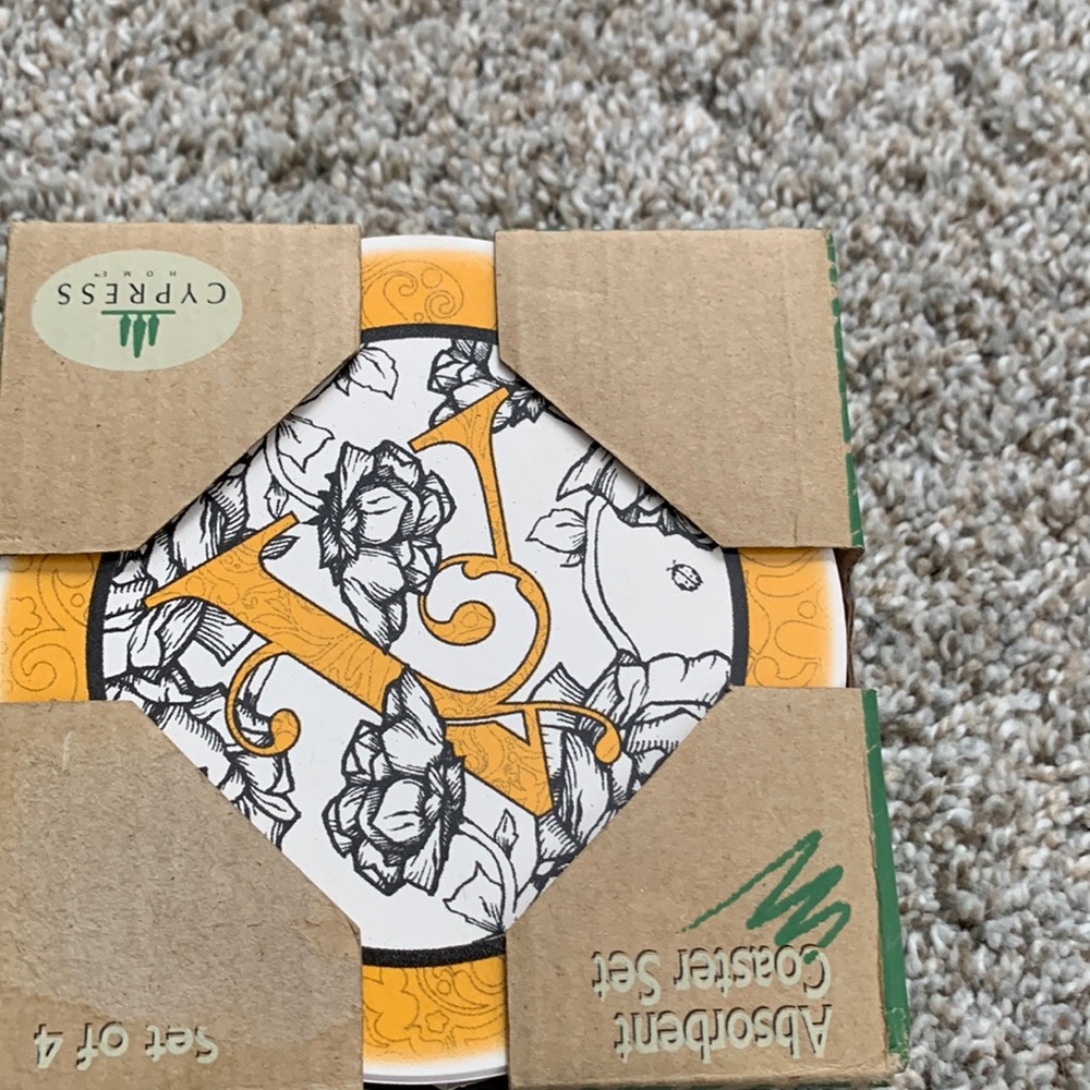 NWT set of 4 coasters with letter “V” on them.  Coaster size is 4x4